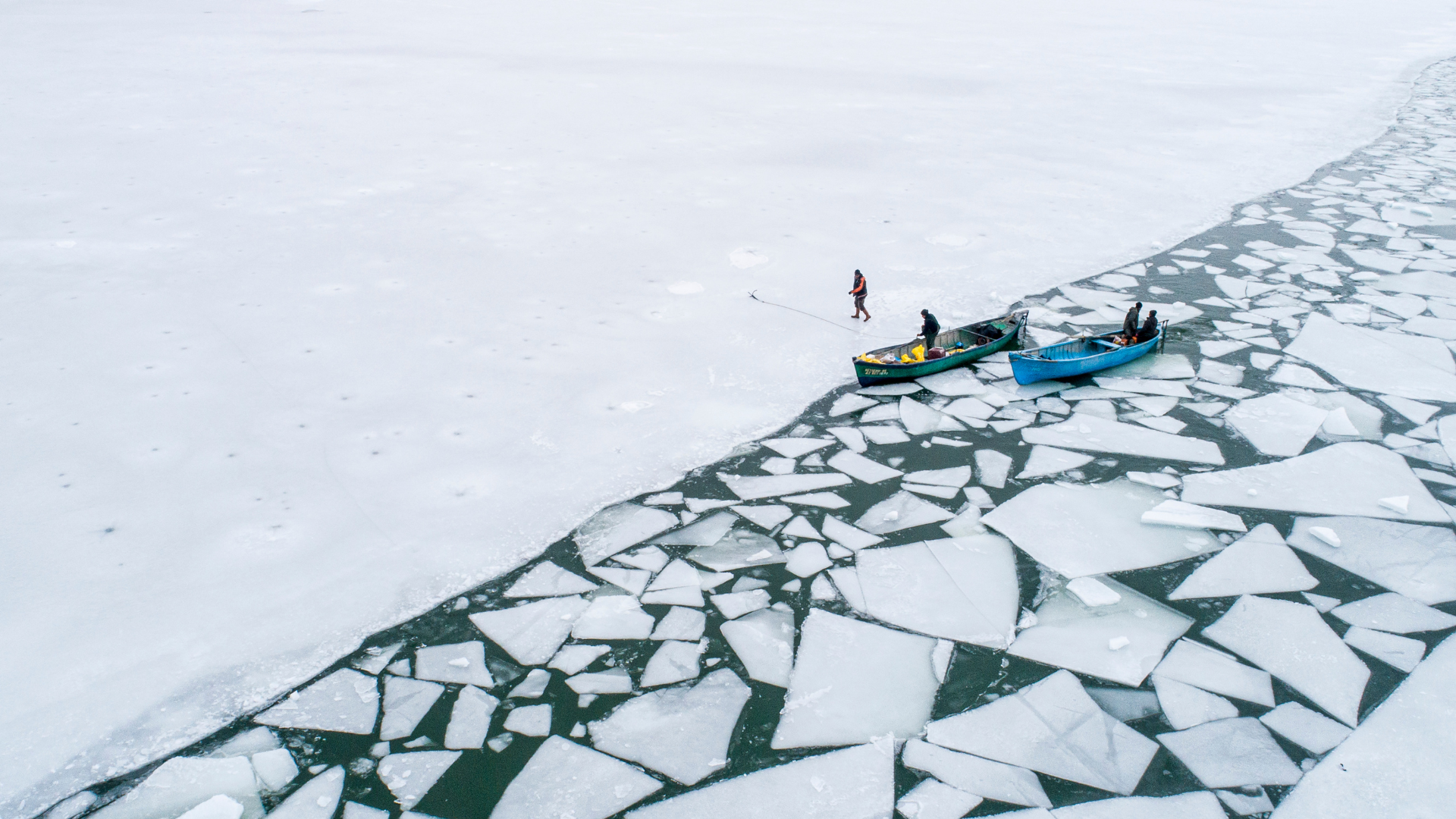 Fishermen on a frozen lake edge